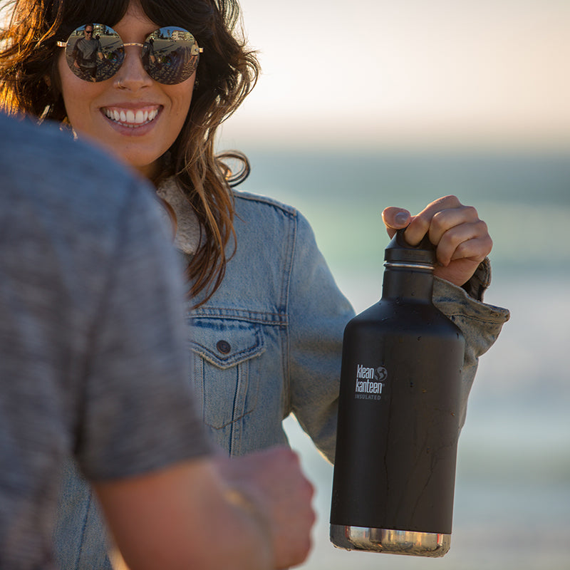 64oz-classic-with-loop-cap-f7 64oz_insulated_classic_black_beach_girl_hand_square.jpg